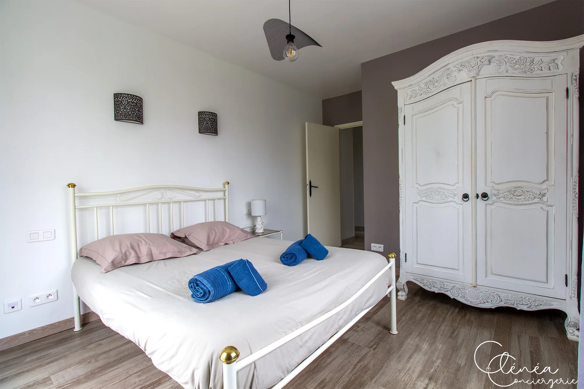 L’Escapade Albigeoise — Chambre avec lit en fer forgé blanc et grande armoire ancienne en bois peint