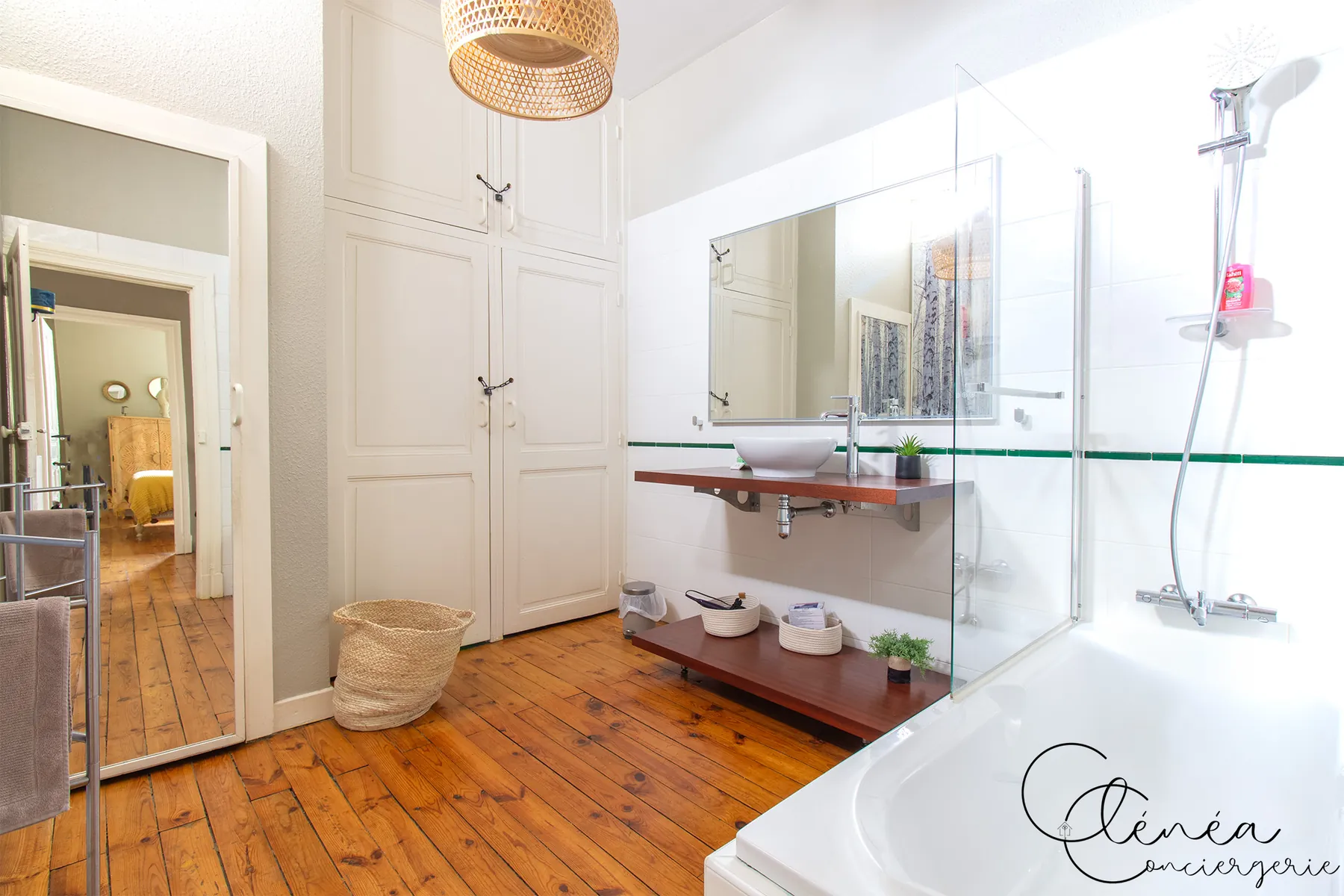 Évasion — Salle de bain avec baignoire, double vasque sur plan en bois et parquet